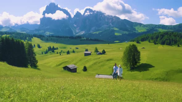 Couple Men and Woman on Vacation in the Dolomites ItalyAlpe Di Siusi  Seiser Alm South Tyrol Italy alt