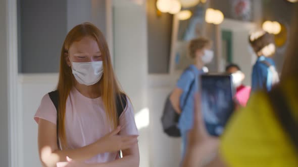 Students Filming on Smartphone Camera Dancing Classmate in Safety Mask alt