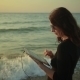 Woman Uses Tablet Pc At The Seaside  - VideoHive Item for Sale