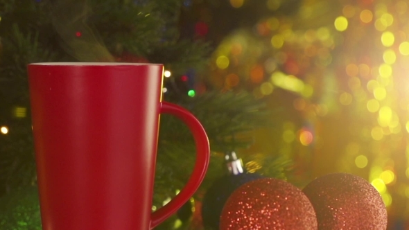 Red Cup Of Steaming Coffee Next To a Decorated