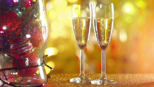 Two Glasses Of Champagne With Bokeh Lights In The