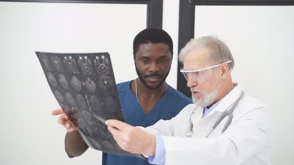 Doctor Looking at CT Scan of Patient's Brain
