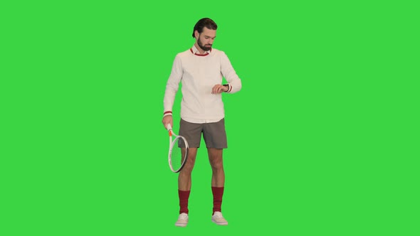 Handsome Male Tennis Player Looking on His Smart Watch on a Green Screen Chroma Key