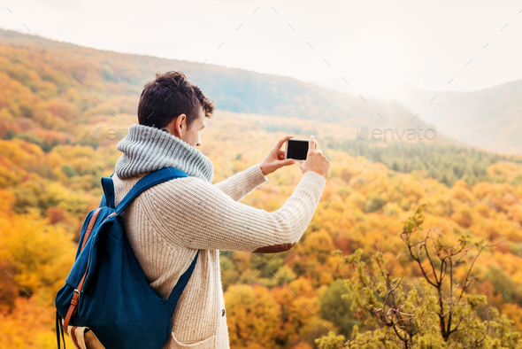 Handsome young man in autumn nature - Stock Photo - Images
