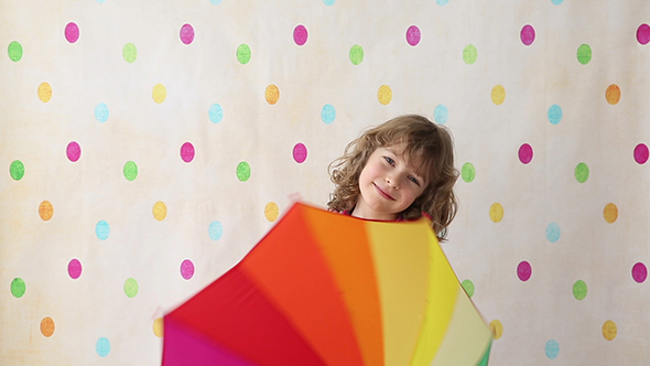Happy Child Playing With Umbrella