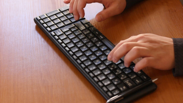 Hands Typing On Computer Keyboard