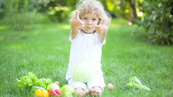 Happy Child Eating Vegetables