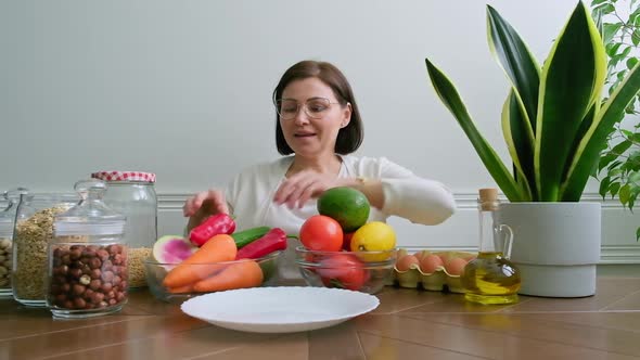 Woman Nutritionist Showing Healthy Food Plate with Vegetables Fruits Grains Nuts alt
