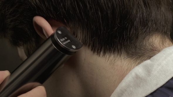 Barber Cutting Hair With Electric Clipper 