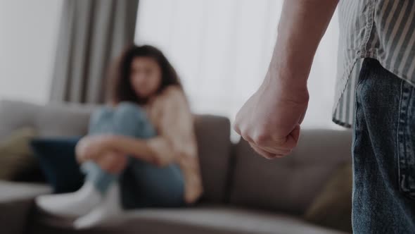 Man Hand Close Up Ready to Beat Up His Woman Sitting on the Ground and Protecting Herself Domestic alt