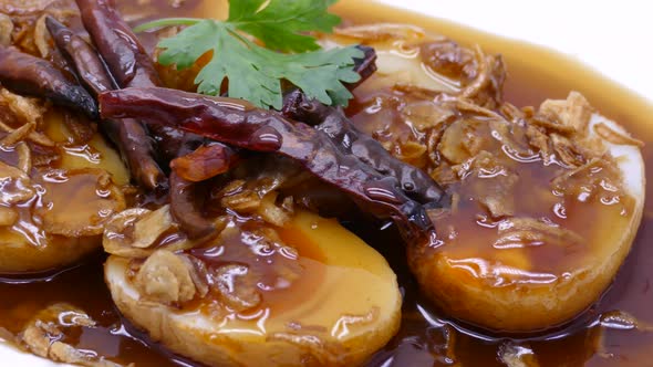 Close-up Footage of Son In Law Egg (Kai Look Kuey), Deep Fried Egg with Sweet and Sour Tamarind Sauc alt