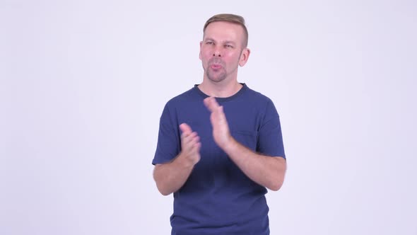 Portrait of Happy Blonde Man Clapping Hands alt