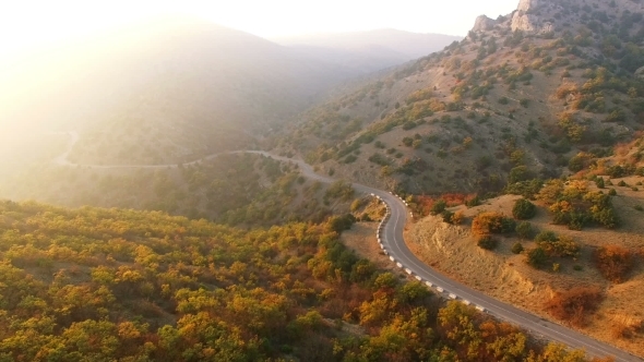 Flying Above Autumn Forest With Mountain Road alt