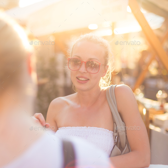 Female friends enjoying a conversation on market.