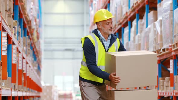 Warehouse worker suffering from back pain while working alt