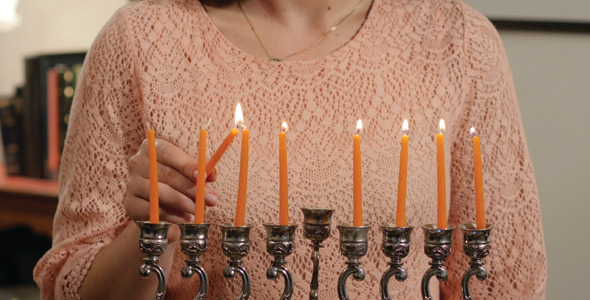 Lighting Orange Hanukkah Candles