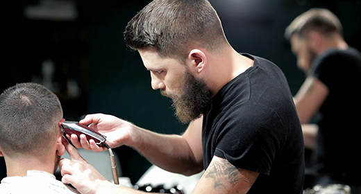 Men's hairstyling and haircutting in a barber shop or hair salon