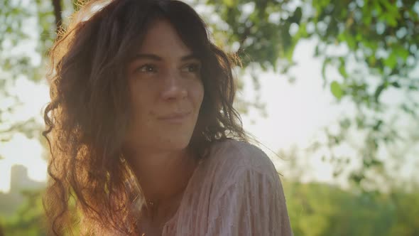 Pivoting Around Close Up Portrait Young Adult Curly Caucasian Woman with Freckles Looking at Camera alt