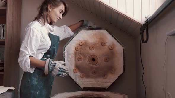 Potter Preparing the Pottery Kiln for the Baking Process for Her Dish alt
