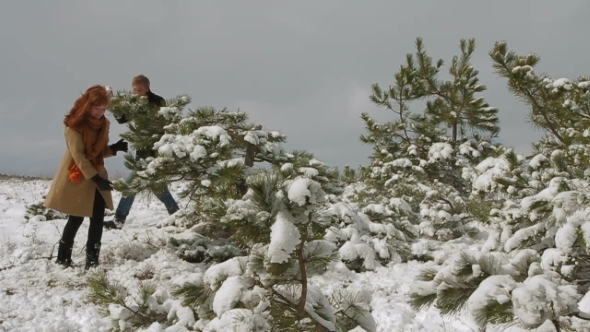 Happy Couple Playing Snowballs In Winter Park