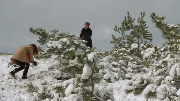 Happy Couple Playing Snowballs In Winter Park