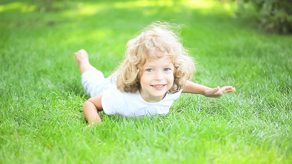Child Lying Outdoors In Spring