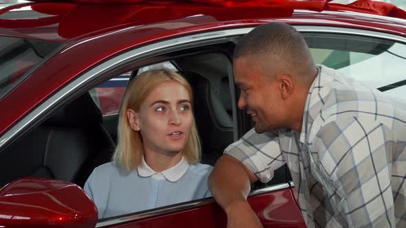 Cheerful Young Couple Buying New Automobile alt