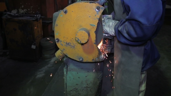 Man Grinding Blank Detail With Sparks
