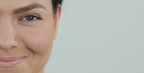 Woman's Half Face Smiling to Camera