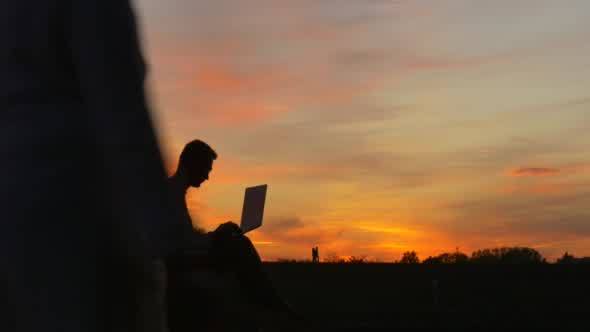 Man is Sitting on The Ground Man's Silhouette alt