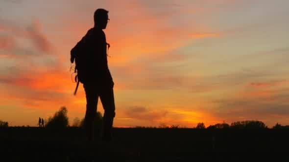 Man With Backpack Man's Silhouette at The Sunset alt
