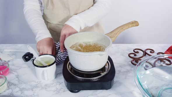 Step by step. Caramelizing sugar in a small cooking pot over the small electric stove alt