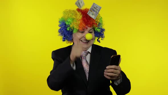 Clown Businesswoman Freelancer Receives Money Income While Using Mobile Phone alt