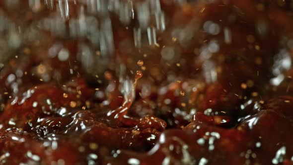 Super Slow Motion Macro Shot of Splashing Fresh Coffee and Water Droplets at 1000 Fps alt