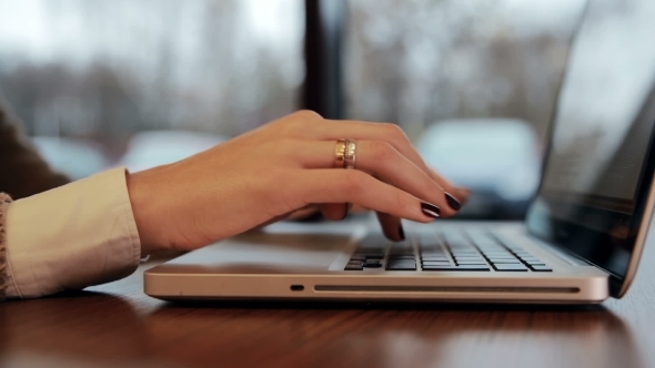 Woman Hands Working On Laptop In Cafe alt