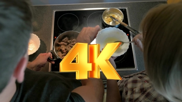 Couple Cooking Together Meat And Sauce alt
