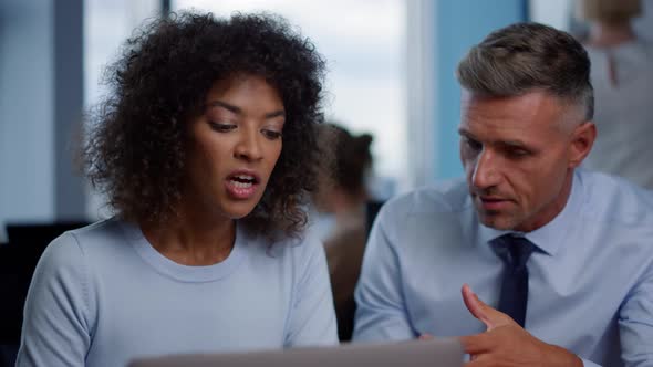 Multiethnic Colleagues Discussing Business Plans in Office, Two Managers Working alt