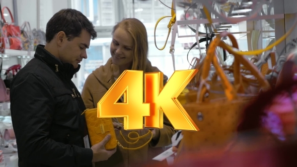 Family Couple Buying Ladies Handbag In The Store alt