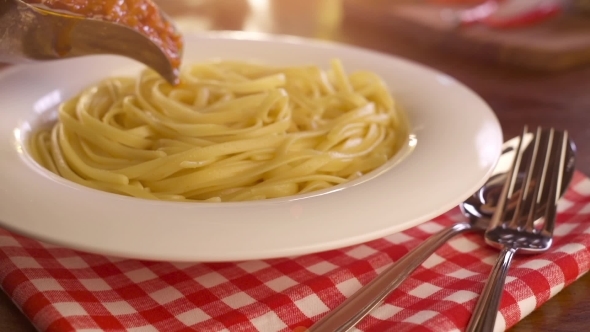Pouring Sauce Onto Spaghetti