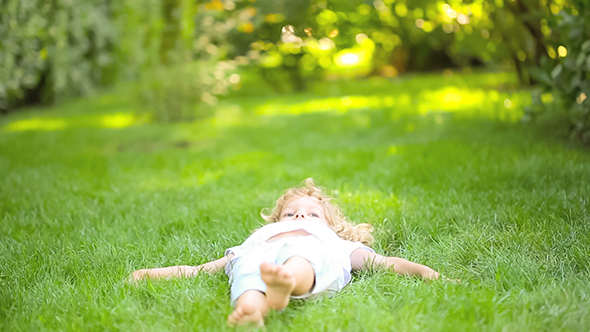Child Lying On Grass