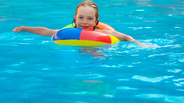 Happy Child Having Fun In Swimming Pool alt