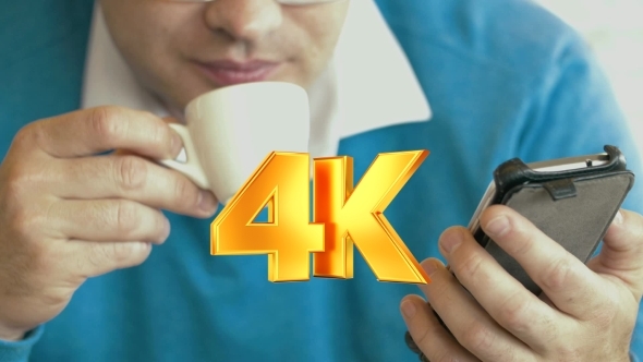 Adult Man Using Smartphone And Drinking Coffee alt