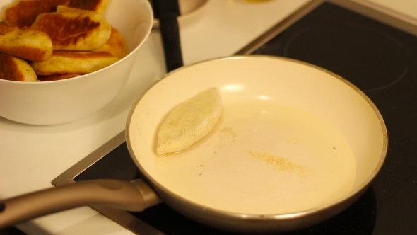 Placing Homemade Cakes In The Pan For Frying