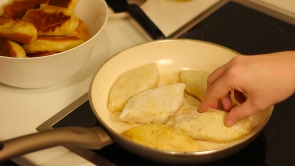 Placing Homemade Cakes In The Pan For Frying