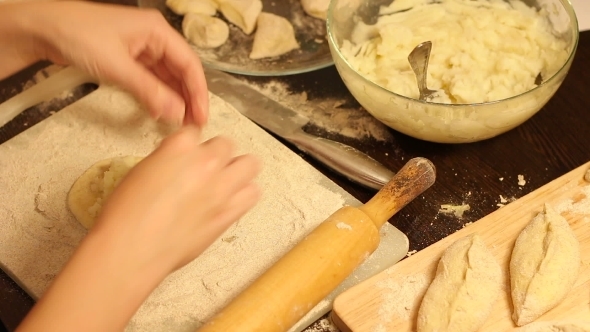 Rolling Out Dough With a Rolling Pin In Hand
