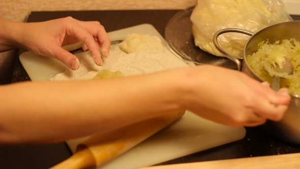 Rolling Out Dough With a Rolling Pin In Hand