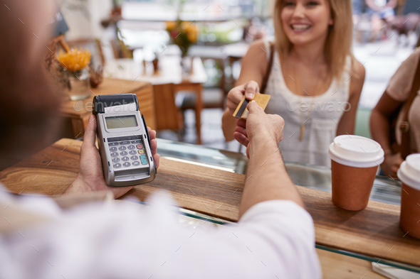 Customer paying at a cafe with credit card - Stock Photo - Images