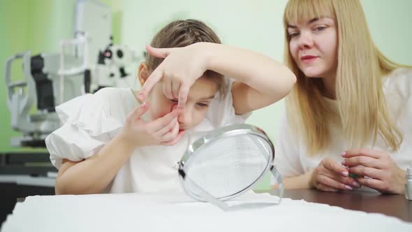 an Ophthalmologist Teaches Girl to Put on Orthokeratological Contact Lenses alt