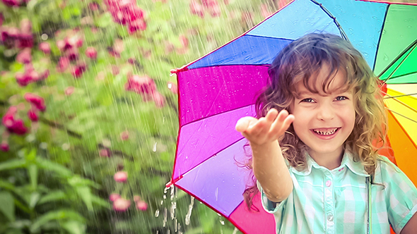 Happy Child Walking In The Rain