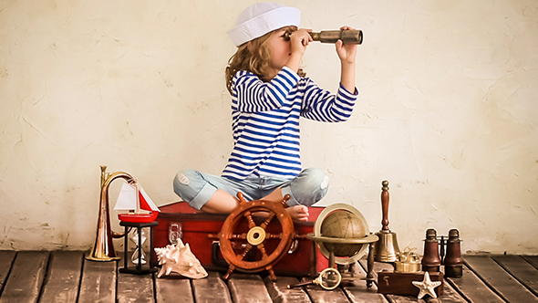 Happy Kid Playing With Nautical Vintage Toys alt